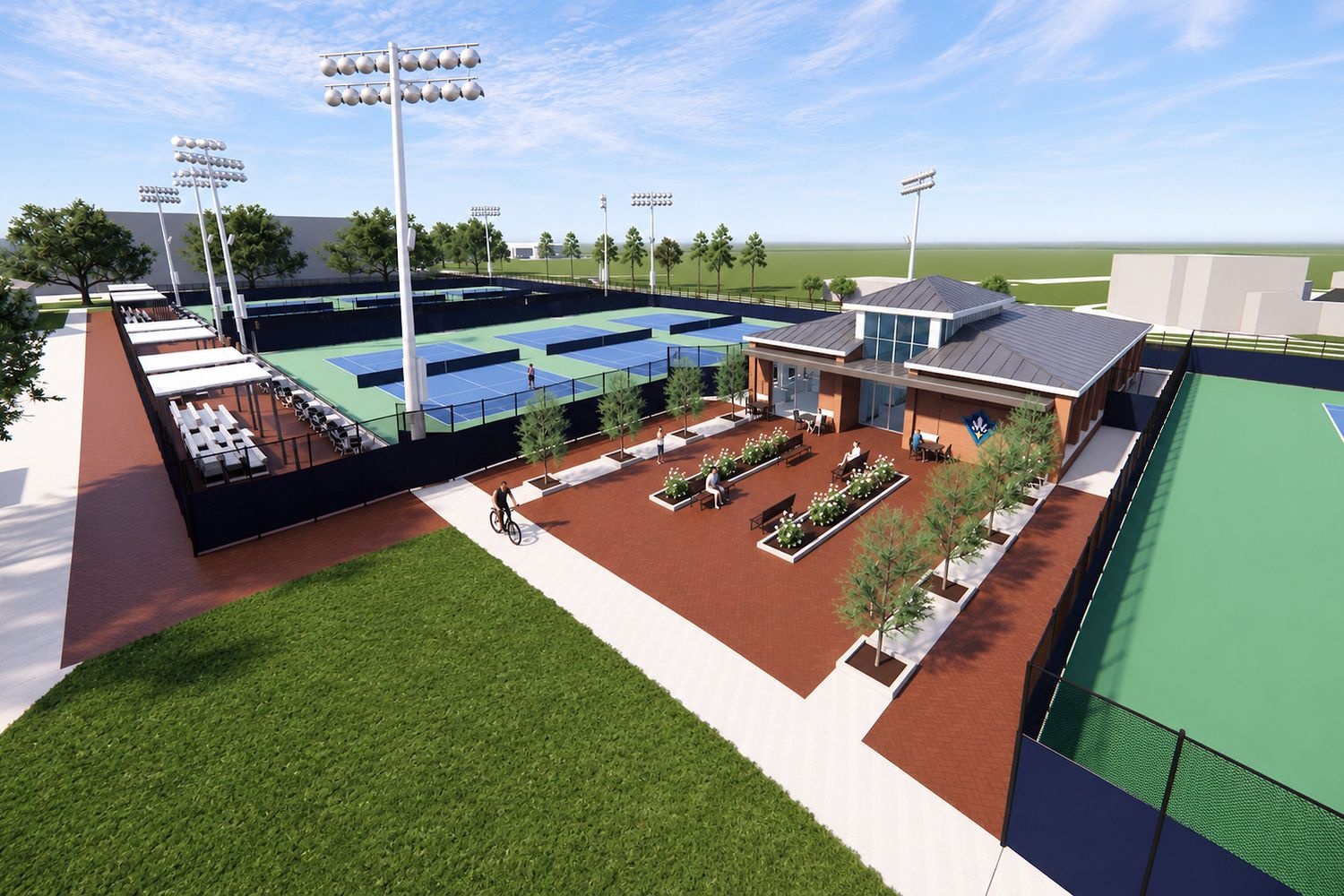 A modern tennis facility featuring multiple courts, a central building with seating areas, and surrounding greenery under a clear sky.